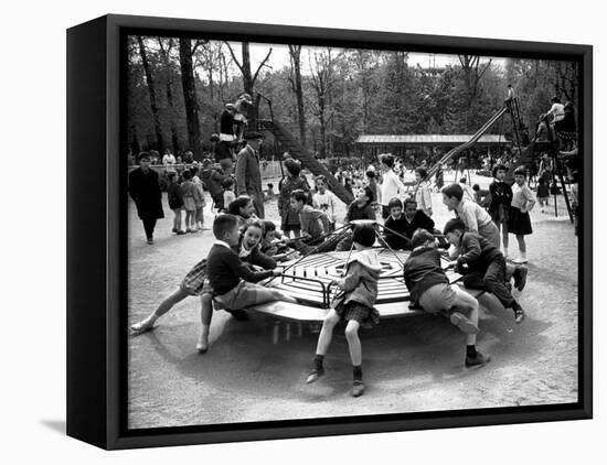 Parisian Children Riding Merry Go Round in a Playground-Alfred Eisenstaedt-Framed Stretched Canvas