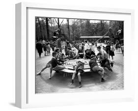 Parisian Children Riding Merry Go Round in a Playground-Alfred Eisenstaedt-Framed Photographic Print