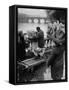 Parisian Flower Vendor at Work Stocking His Stall on the Seine with the Pont Neuf in the Background-Ed Clark-Framed Stretched Canvas