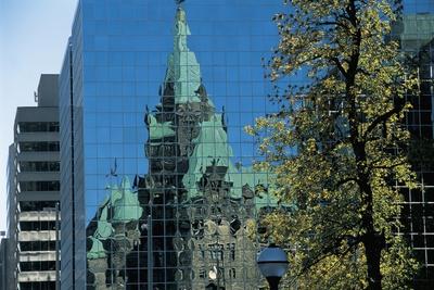 https://imgc.allpostersimages.com/img/posters/parliament-building-reflecting-in-a-skyscraper-ottawa-ontario-canada_u-L-PV7LQV0.jpg?artPerspective=n
