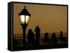 Passengers on a Ferry Pass a Street Lamp on the Waterfront at Battery Park-null-Framed Stretched Canvas