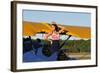 Patriotic Pin-Up Girl Standing Inside the Cockpit of a Stearman Biplane-null-Framed Photographic Print