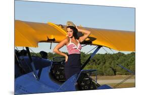 Patriotic Pin-Up Girl Standing Inside the Cockpit of a Stearman Biplane-null-Mounted Photographic Print