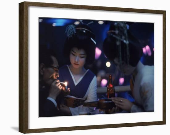 Patron of Nightclub Uruwashi Having His Cigarette Lit by Geisha-Eliot Elisofon-Framed Photographic Print