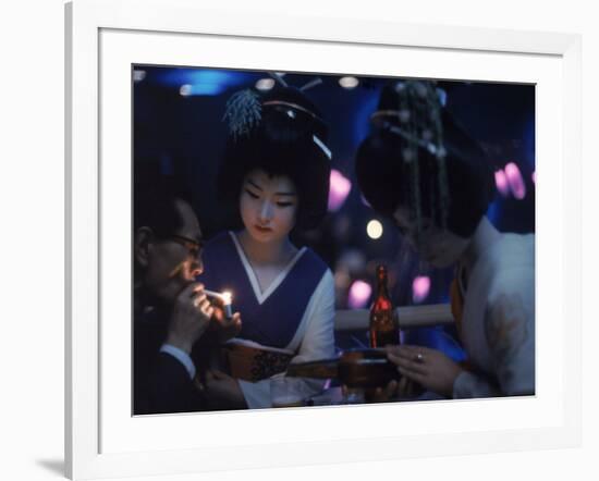 Patron of Nightclub Uruwashi Having His Cigarette Lit by Geisha-Eliot Elisofon-Framed Photographic Print