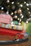 Toy Train Running Beneath Christmas Tree-Pauline St. Denis-Photographic Print