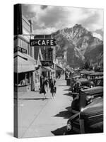 Pedestrians Walking Along Main Street in Resort Town with Cascade Mountain in the Background-Andreas Feininger-Stretched Canvas