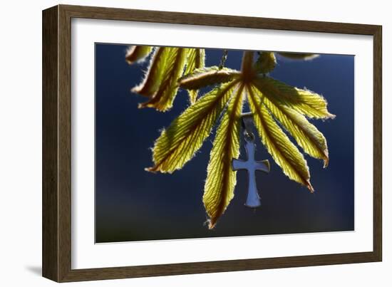 Pendant with cross on a young green chestnut leaf at springtime-null-Framed Giclee Print