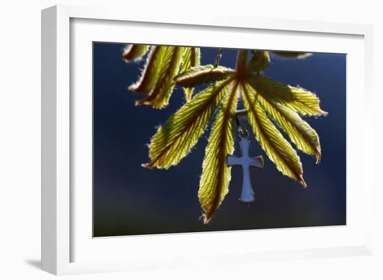 Pendant with cross on a young green chestnut leaf at springtime-null-Framed Giclee Print