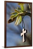 Pendant with cross on a young green chestnut leaf at springtime-null-Framed Giclee Print