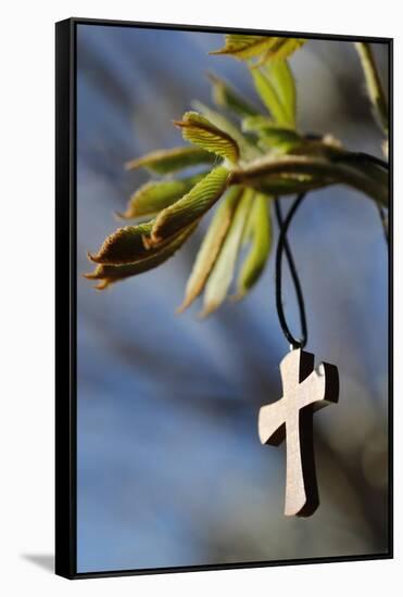 Pendant with cross on a young green chestnut leaf at springtime-null-Framed Stretched Canvas