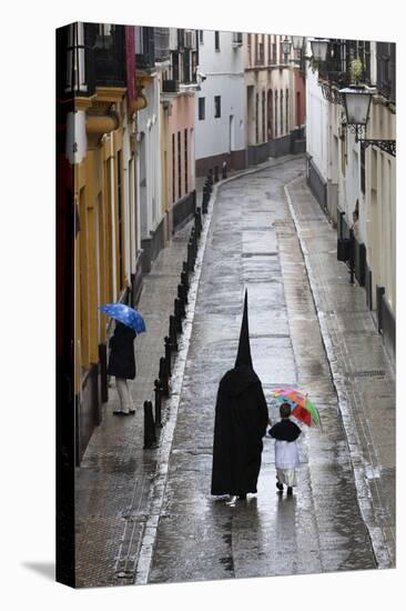 Penitents During Semana Santa (Holy Week) Along Rainy Street, Seville, Andalucia, Spain, Europe-Stuart Black-Stretched Canvas