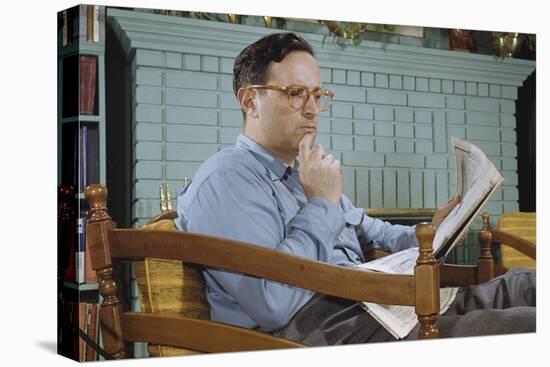 Pensive Man Reading Newspaper in Living Room-William P. Gottlieb-Stretched Canvas