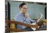 Pensive Man Reading Newspaper in Living Room-William P. Gottlieb-Mounted Photographic Print