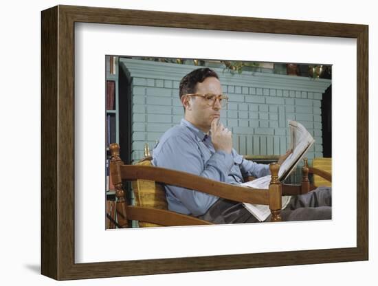 Pensive Man Reading Newspaper in Living Room-William P. Gottlieb-Framed Photographic Print