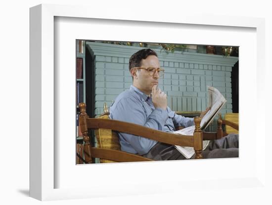 Pensive Man Reading Newspaper in Living Room-William P. Gottlieb-Framed Photographic Print