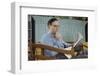 Pensive Man Reading Newspaper in Living Room-William P. Gottlieb-Framed Photographic Print