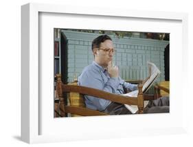 Pensive Man Reading Newspaper in Living Room-William P. Gottlieb-Framed Photographic Print