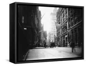 People and Horse Drawn Carts on Wall St, Where American Flags Fly from Buildings-George B^ Brainerd-Framed Stretched Canvas