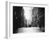 People and Horse Drawn Carts on Wall St, Where American Flags Fly from Buildings-George B^ Brainerd-Framed Photographic Print