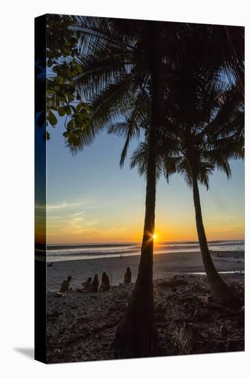 People by Palm Trees at Sunset on Playa Hermosa Beach, Santa Teresa, Costa Rica-Rob Francis-Stretched Canvas