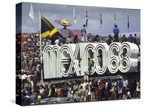 People Climbing and Sitting on a Mexico '68 Sign at the Summer Olympics-John Dominis-Stretched Canvas