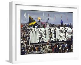 People Climbing and Sitting on a Mexico '68 Sign at the Summer Olympics-John Dominis-Framed Photographic Print