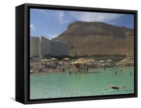 People Floating in the Sea and Hyatt Hotel and Desert Cliffs in Background, Dead Sea, Middle East-Eitan Simanor-Framed Stretched Canvas