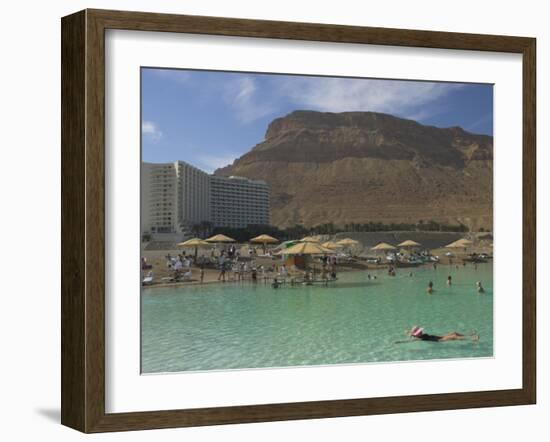 People Floating in the Sea and Hyatt Hotel and Desert Cliffs in Background, Dead Sea, Middle East-Eitan Simanor-Framed Photographic Print