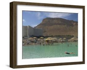 People Floating in the Sea and Hyatt Hotel and Desert Cliffs in Background, Dead Sea, Middle East-Eitan Simanor-Framed Photographic Print