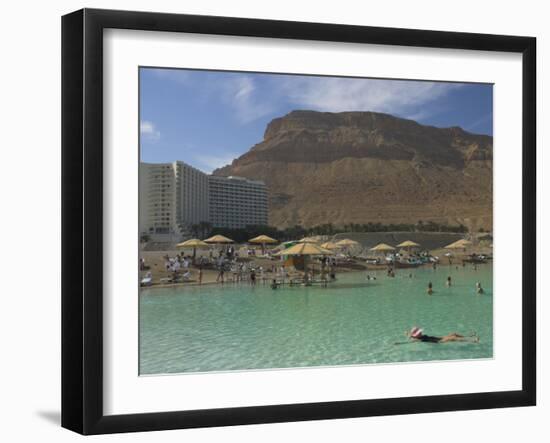 People Floating in the Sea and Hyatt Hotel and Desert Cliffs in Background, Dead Sea, Middle East-Eitan Simanor-Framed Photographic Print