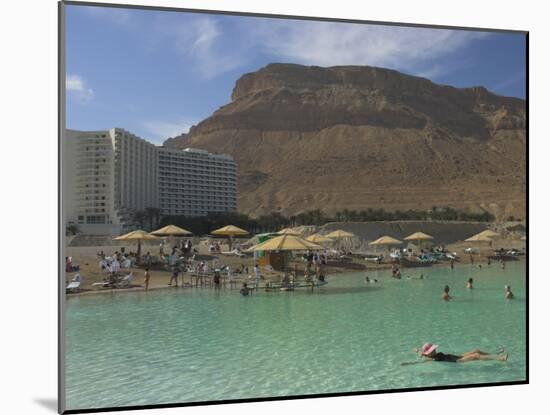 People Floating in the Sea and Hyatt Hotel and Desert Cliffs in Background, Dead Sea, Middle East-Eitan Simanor-Mounted Photographic Print