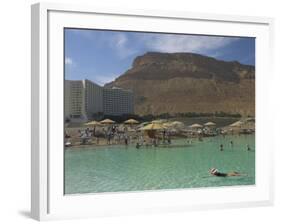 People Floating in the Sea and Hyatt Hotel and Desert Cliffs in Background, Dead Sea, Middle East-Eitan Simanor-Framed Photographic Print