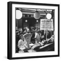 People Looking at Meat in Meat Store While Butchers Measure Out Meats-Yale Joel-Framed Photographic Print