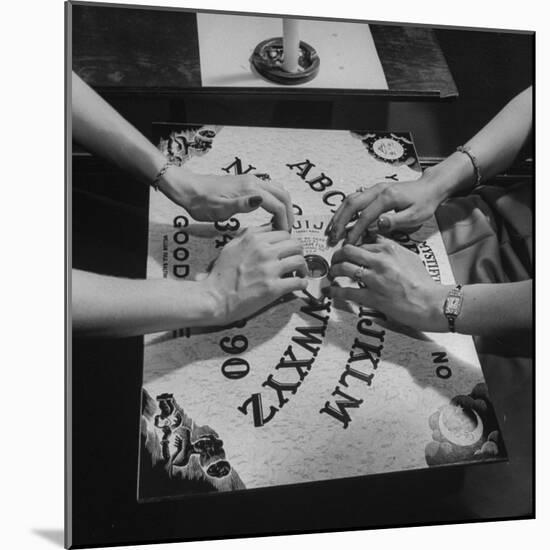 People Playing with a Ouija Board-null-Mounted Photographic Print