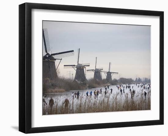 People Skate on Frozen Canals in Kinderdijk's Mill Area, a UNESCO World Heritage Site, Netherlands-null-Framed Premium Photographic Print