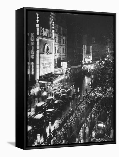 People Waiting in Front of the Brightly Lighted Empire Theatre for the Royal Film Performance-Cornell Capa-Framed Stretched Canvas