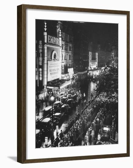 People Waiting in Front of the Brightly Lighted Empire Theatre for the Royal Film Performance-Cornell Capa-Framed Photographic Print