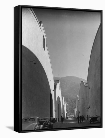People Walking Between Sound Stages at Warner Bros. Studio-Margaret Bourke-White-Framed Stretched Canvas