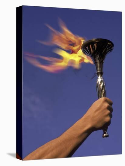 Person's Hand Holding a Flaming Torch-null-Stretched Canvas