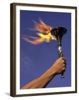 Person's Hand Holding a Flaming Torch-null-Framed Premium Photographic Print
