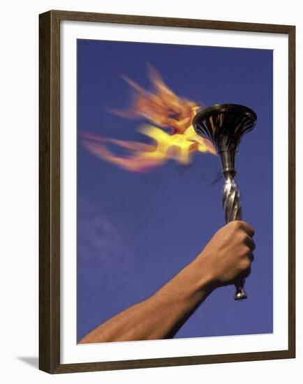 Person's Hand Holding a Flaming Torch-null-Framed Premium Photographic Print