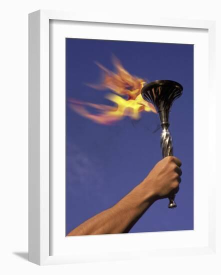 Person's Hand Holding a Flaming Torch-null-Framed Photographic Print