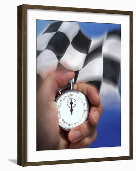 Person's Hand Holding a Stopwatch in Front of a Checkered Flag-null-Framed Photographic Print