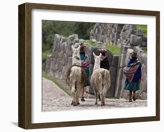 Peru, Native Indian Women Lead their Llamas Past the Ruins of Saqsaywaman-Nigel Pavitt-Framed Photographic Print