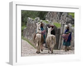 Peru, Native Indian Women Lead their Llamas Past the Ruins of Saqsaywaman-Nigel Pavitt-Framed Photographic Print