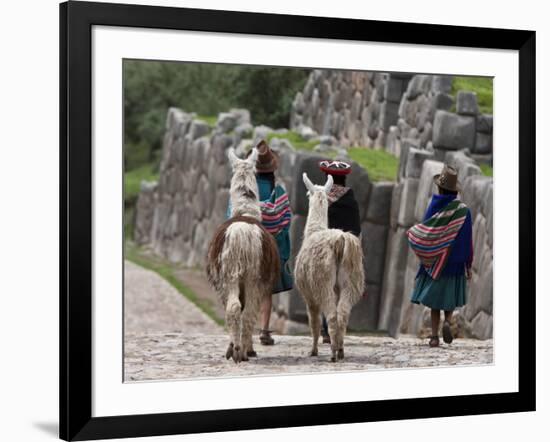 Peru, Native Indian Women Lead their Llamas Past the Ruins of Saqsaywaman-Nigel Pavitt-Framed Photographic Print