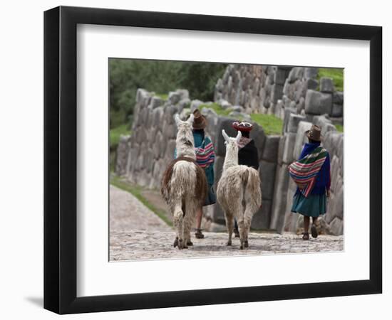 Peru, Native Indian Women Lead their Llamas Past the Ruins of Saqsaywaman-Nigel Pavitt-Framed Photographic Print