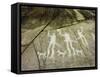 Petroglyph with three men brandishing axes, accompanied by dogs-Werner Forman-Framed Stretched Canvas