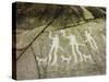 Petroglyph with three men brandishing axes, accompanied by dogs-Werner Forman-Stretched Canvas